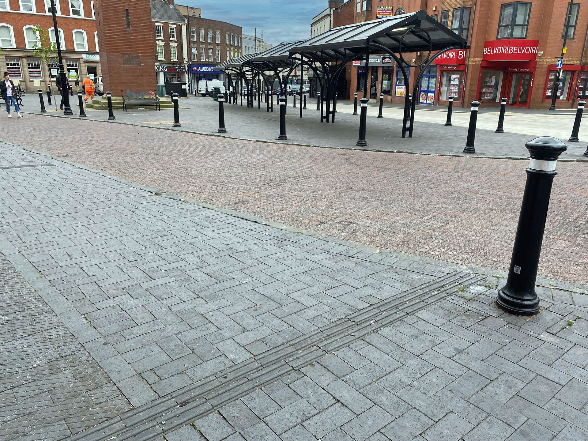blue square edged pavers with brown brindle star pavers and blue diamond chequer pavers were used to regenerate Market Place in Wednesbury